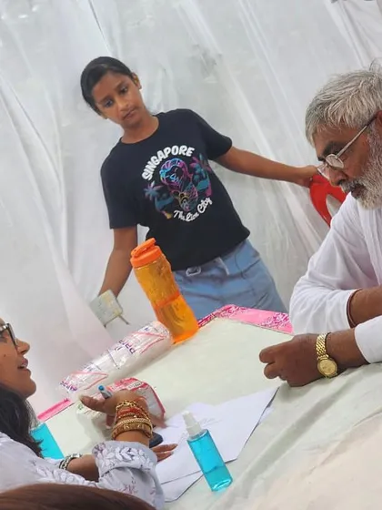 For me, nutrition is about community. Here I am at a medical camp, providing diet consultations. Making expert advice accessible to everyone is a core part of my mission and a way of continuing my father's vision of service.