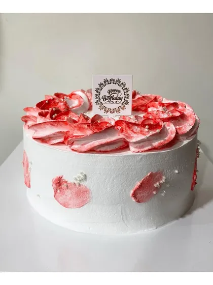 A simple half-kg mix fruit cake with a red and white color palette. The abstract petal design is both modern and pretty.