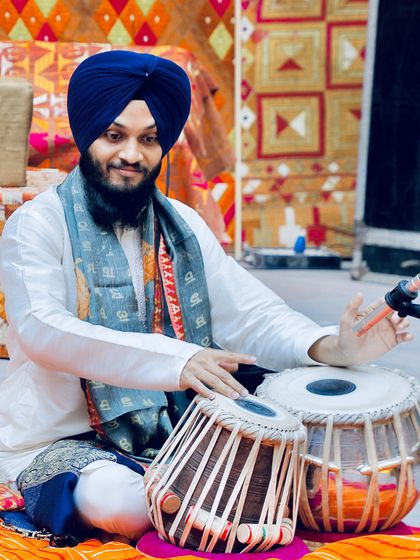 A performance at the India Habitat Centre in New Delhi. The colorful backdrop adds to the festive atmosphere.