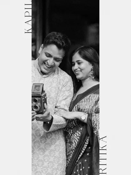 An artistic portrait of the couple, their names framing a joyful, candid moment.