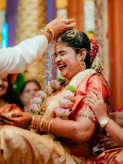 The pure, unscripted joy of a traditional Hindu wedding ceremony. I live for capturing these peak emotional moments, like the showering of rice, that you'll cherish forever.
