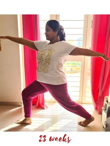 A powerful Warrior II pose (Virabhadrasana II) at 23 weeks, building strength and confidence.