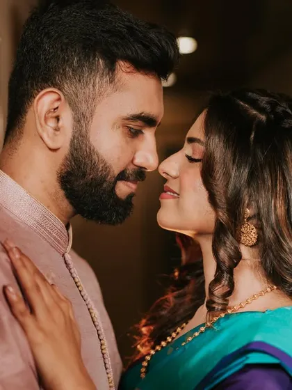 A close and intimate couple portrait. The bride's makeup is soft and romantic, enhancing her natural beauty.