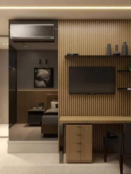 The mirrored panel next to the study desk cleverly conceals a wardrobe while making the room appear larger.