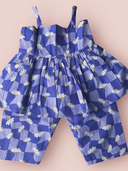 I love mixing patterns, like this fun checkered and daisy print. This blue co-ord set is so unique and playful, perfect for your little trendsetter.