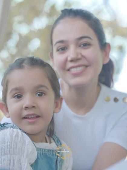 A lovely portrait of a mother and daughter smiling for the camera during their outdoor family session.