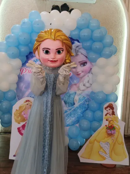 Our Elsa mascot posing for photos in front of the themed backdrop.