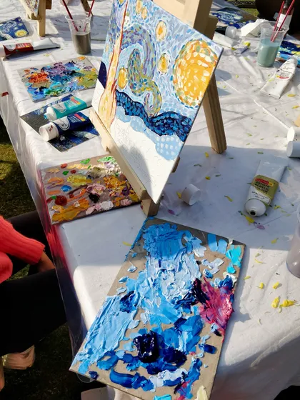 A behind the scenes look at the creative mess of our "Starry Night" painting event, with palettes full of color and works in progress.