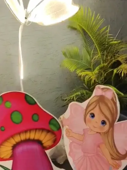 Close-up of the whimsical props I used for the butterfly garden theme, including a fairy cutout, a mushroom, and a lighted butterfly, adding a magical touch to the decor.