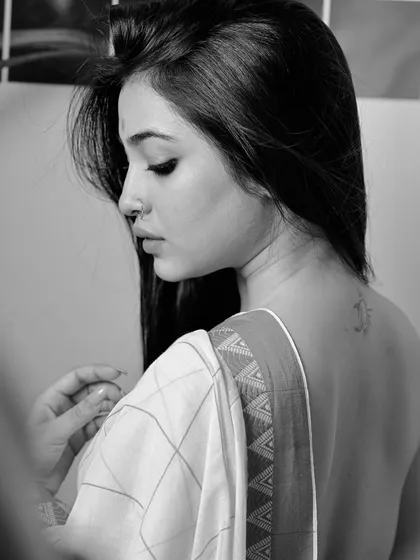 A simple yet evocative black and white back portrait. The focus on the model's bare back and the simple drape of the saree creates a minimalist and artistic image.