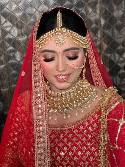 Another angle showing the soft smile of a happy bride. The makeup is designed to look beautiful both in pictures and in person.