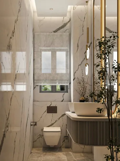 In this powder room, I used floor-to-ceiling marble to create a dramatic and luxurious feel. The wall-mounted toilet and floating vanity help maximize the sense of space, while the elegant pendant lights and backlit mirror add a layer of sophisticated, warm lighting.