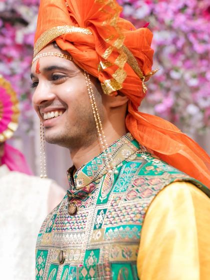 A candid portrait of the smiling groom during his wedding ceremony.