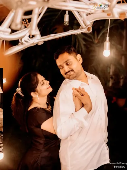 A romantic indoor night shoot where a couple dances under creative lighting made from bicycle parts and exposed bulbs.