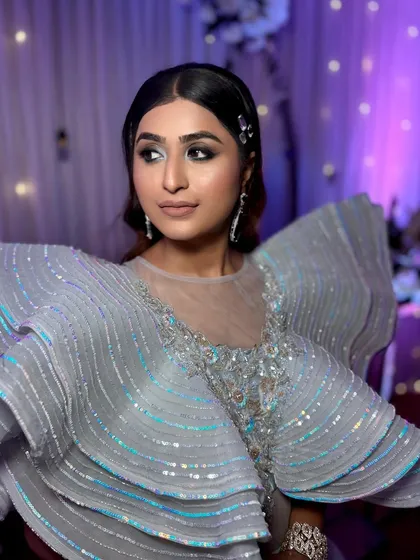 Glammed up for a perfect cocktail night. This look features a dramatic, structured gown paired with equally bold and beautiful makeup.