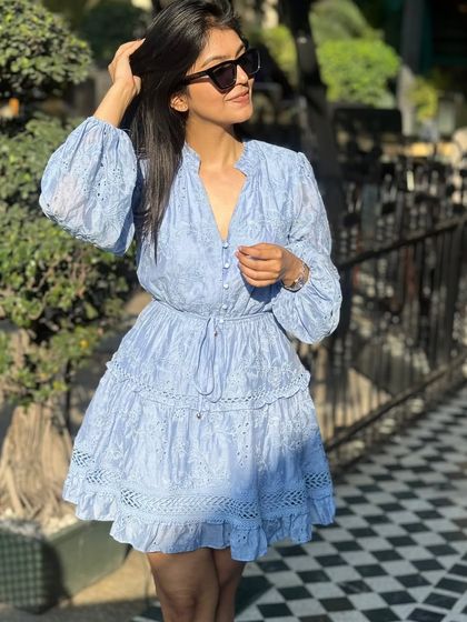 Another look at this beautiful blue dress. The long sleeves and cinched waist create a very flattering silhouette.