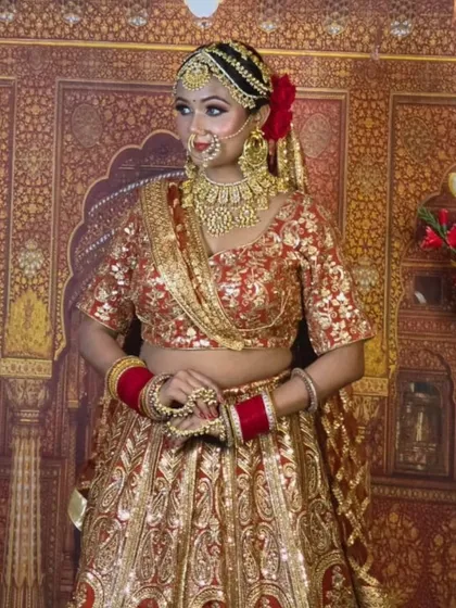 This red and gold brocade lehenga is a timeless choice. It's paired with a full gold jewellery set for a classic, all-gold bridal look.