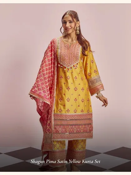 The Shagun Pima Satin Yellow Kurta Set is a perfect pick for Karwa Chauth. The bright yellow and pink combination is so festive and happy.