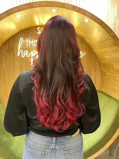 A gorgeous red ombre effect, with darker roots blending seamlessly into vibrant red ends. This style offers a modern and edgy look with beautiful, flowing waves.