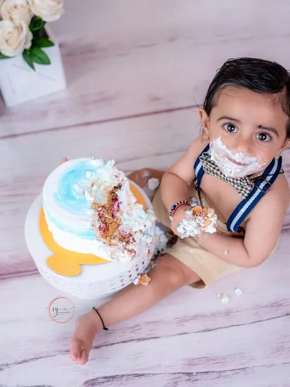 An overhead shot provides a unique perspective of the cake smash, showing just how much fun this little one is having.