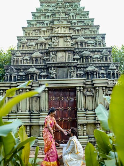 A beautiful portrait of a couple in traditional attire in front of our temple gopuram replica.
