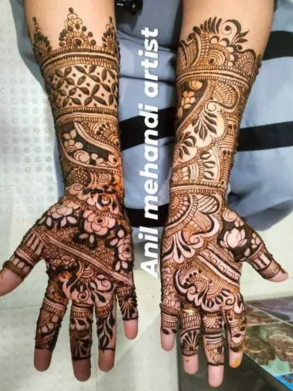 A stunning full-arm mehandi with a variety of traditional patterns. The design combines floral work, geometric grids, and classic motifs for a rich and detailed appearance.
