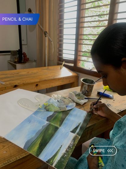 A student paints a serene landscape, learning to blend sky and water seamlessly. Our courses cover essential techniques for capturing the beauty of nature.