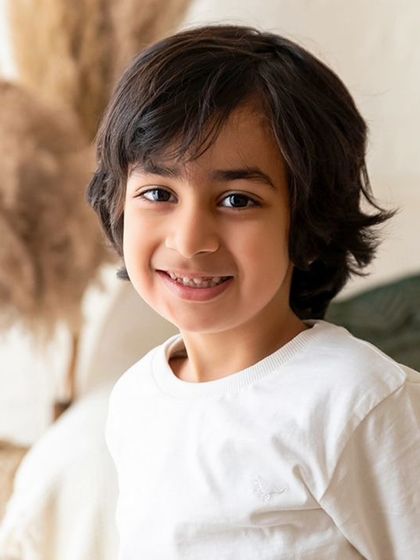 A simple, clean portrait of a young boy in the studio. Individual portraits of each child are an important part of the family photoshoot package.