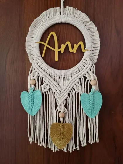 This macrame name wall hanging for 'Ann' is a perfect gifting option for loved ones. The natural cotton combined with pops of turquoise and mustard makes it a cheerful and unique decor piece.