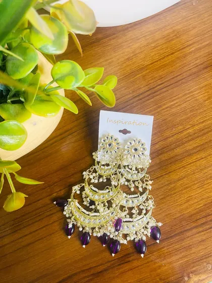 These limited edition tiered chandbalis are perfect for the wedding season. The combination of kundan work with deep purple beads creates a royal look that will definitely get you noticed.