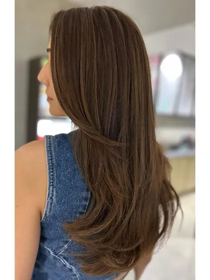 Side view of the warm auburn to cool brown transformation. You can really see how the face-framing layers and cool tones work together to create a sophisticated look.