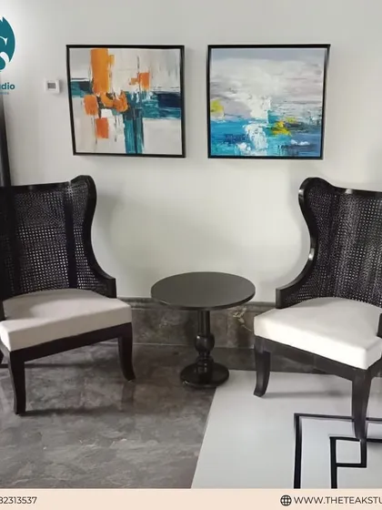 A pair of dramatic high-back chairs, often called "throne chairs," with caned backs and a dark finish. These are perfect for making a grand statement in a formal living room or entryway.