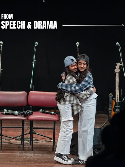 A hug on stage at 'Holiday in Harmony'. Our shows are not just about performance, but also about building friendships and a supportive community among our students.
