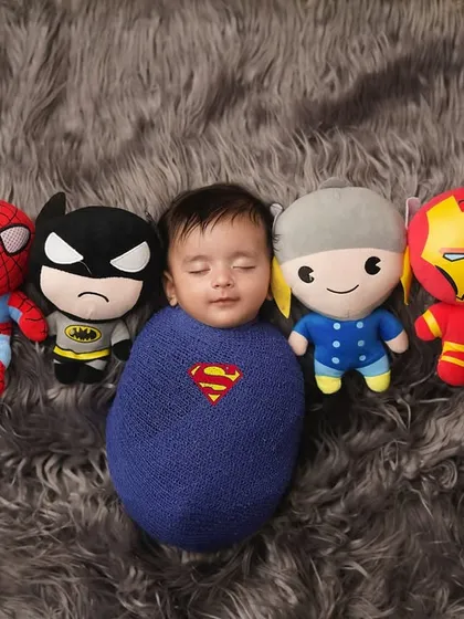 Superman is assembled with his team! This fun shot includes plush toys of other superheroes, creating a playful and colorful composition.