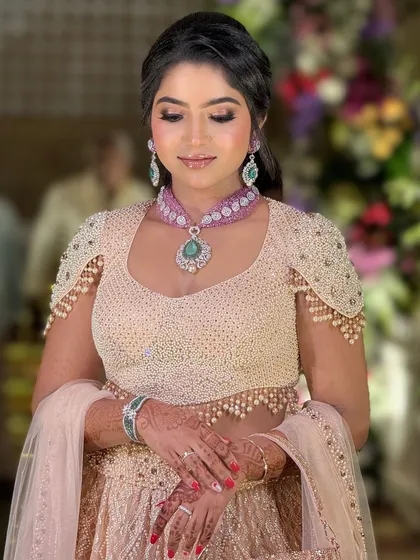 An eyes-closed shot to highlight the soft, shimmery eyeshadow and the flawless finish of her makeup.