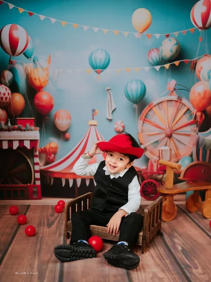Welcome to the carnival. I love bringing big ideas to life, like this vibrant second birthday shoot. From the colorful backdrop to the tiny ringmaster's outfit, every detail is planned to create a world of wonder for your child.
