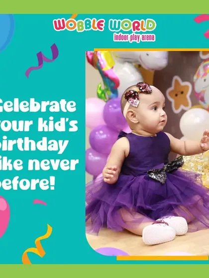A baby celebrating her birthday in a beautiful purple tutu, with a unicorn-themed background. We host parties for children of all ages.