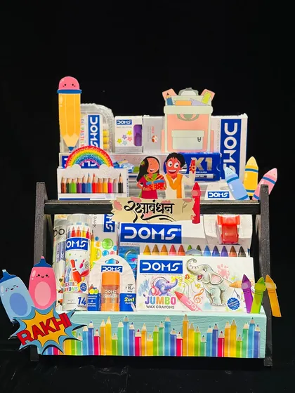 For the budding artist. This Doms stationery hamper is packed with crayons, color pencils, and other art supplies to fuel their creativity this Raksha Bandhan.