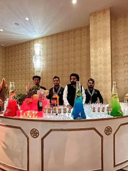 Our team is ready to rock this welcome dinner with a fully stocked molecular bar. The setup features colorful drinks in unique dispensers and a clean, modern look.