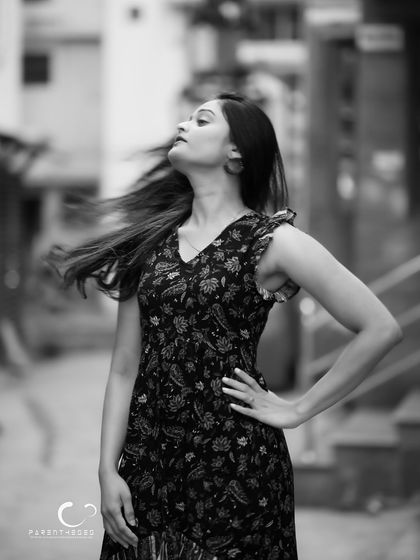 The freedom of movement captured in timeless black and white. The wind whipping her hair creates a dynamic and emotional portrait that feels both wild and graceful.