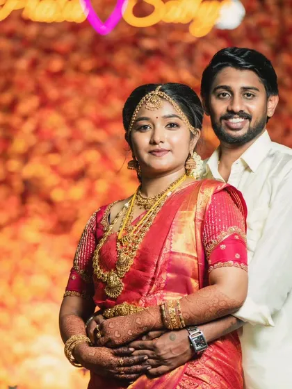 A lovely portrait of the couple on their wedding day. The bride's makeup is perfectly balanced, not overpowering, and looks beautiful against the festive backdrop.