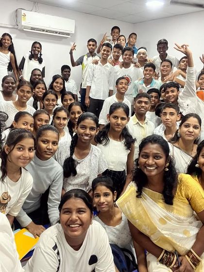 A beautiful group selfie with students and teachers dressed in white for Day 2 of Navratri 2023.
