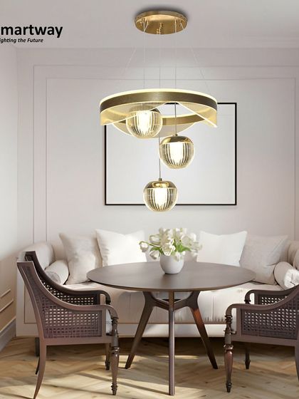 This modern piece combines a ring light with three hanging glass globes. It's a beautiful and functional design for a small dining area or a cozy corner, providing both ambient and focused light.