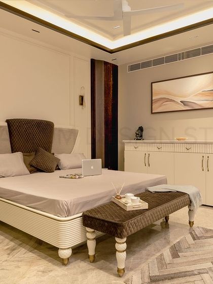 Another view of the parent's bedroom, showcasing the custom-designed bed with a unique headboard and detailed legs, set against a warm, neutral backdrop.