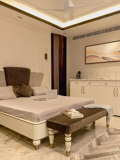 Another view of the parent's bedroom, showcasing the custom-designed bed with a unique headboard and detailed legs, set against a warm, neutral backdrop.