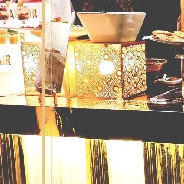 Our setup at Mallu Farms for an elite clientele. The counter features a mix of modern and traditional elements, including a white picket fence detail and elegant table lamps, creating a bespoke look.