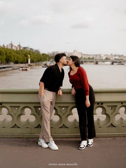 A kiss on a London bridge, with the city's iconic skyline as a witness. For Devi and Milind, I captured their love story in the city where it blossomed, showing that I am ready to travel anywhere your story takes me.