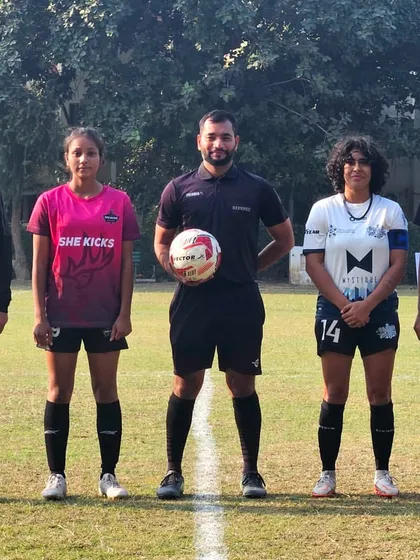 The pre-match lineup. Captains from The Dream Team and She Kicks FA with the referees, ready for kickoff at the women's championship.