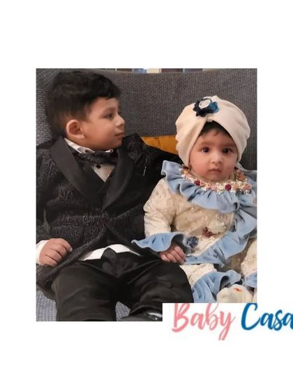 Siblings celebrating Lohri together. The little one is dressed in a beautiful vintage-style outfit, looking adorable next to her big brother.