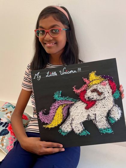 Another magical unicorn string art piece, proudly displayed by its creator. This is one of our most requested designs for kids.